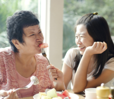 Elder eating with staff